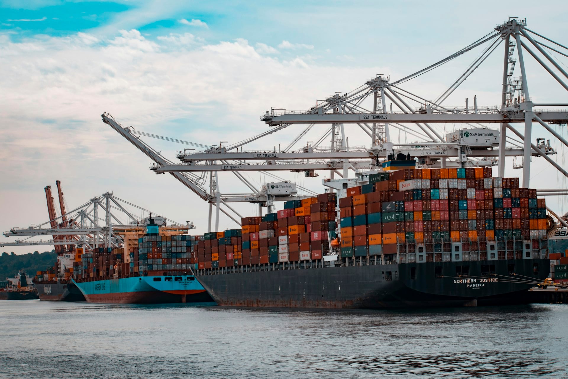 Container ship at port with cargo cranes — logistics coordination