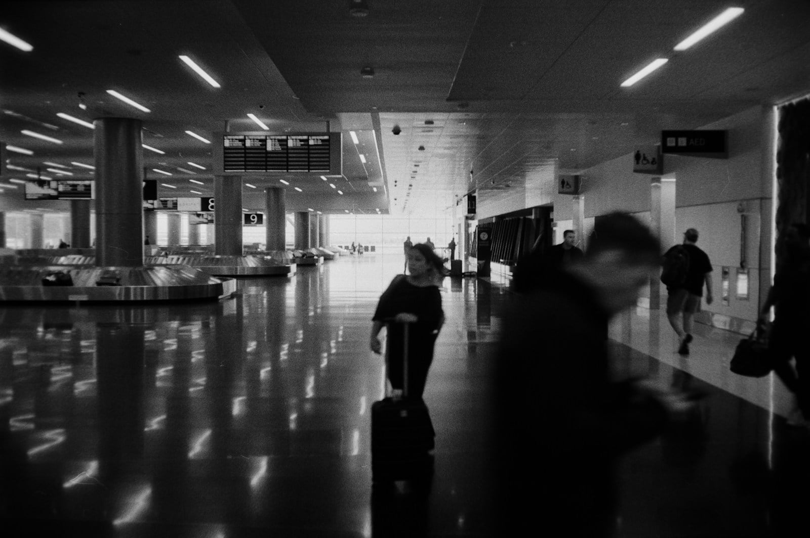 Travellers with luggage in airport terminal — travel accessories